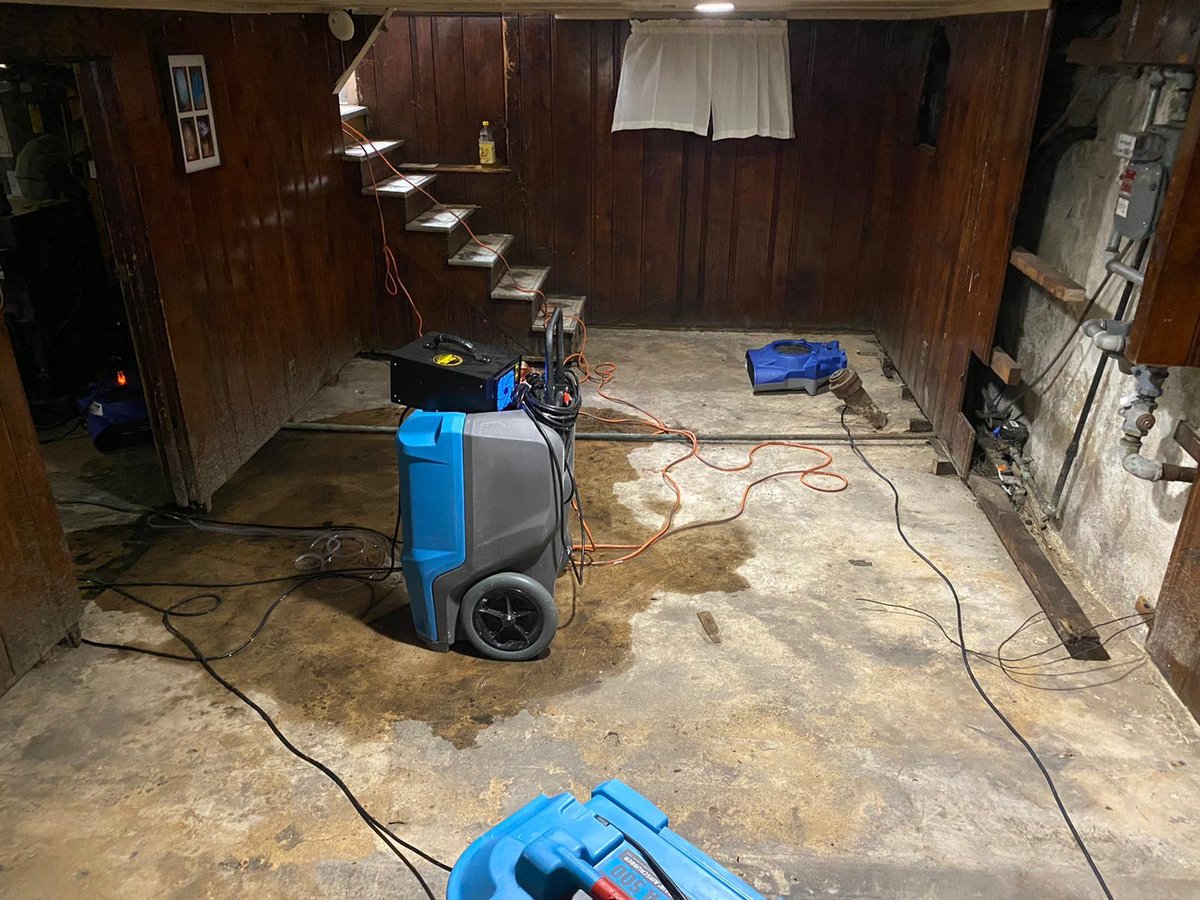 Anajur drying equipment near the access stairs of a finished basement, LGR dehumidifier and air mover on Staten Island.
