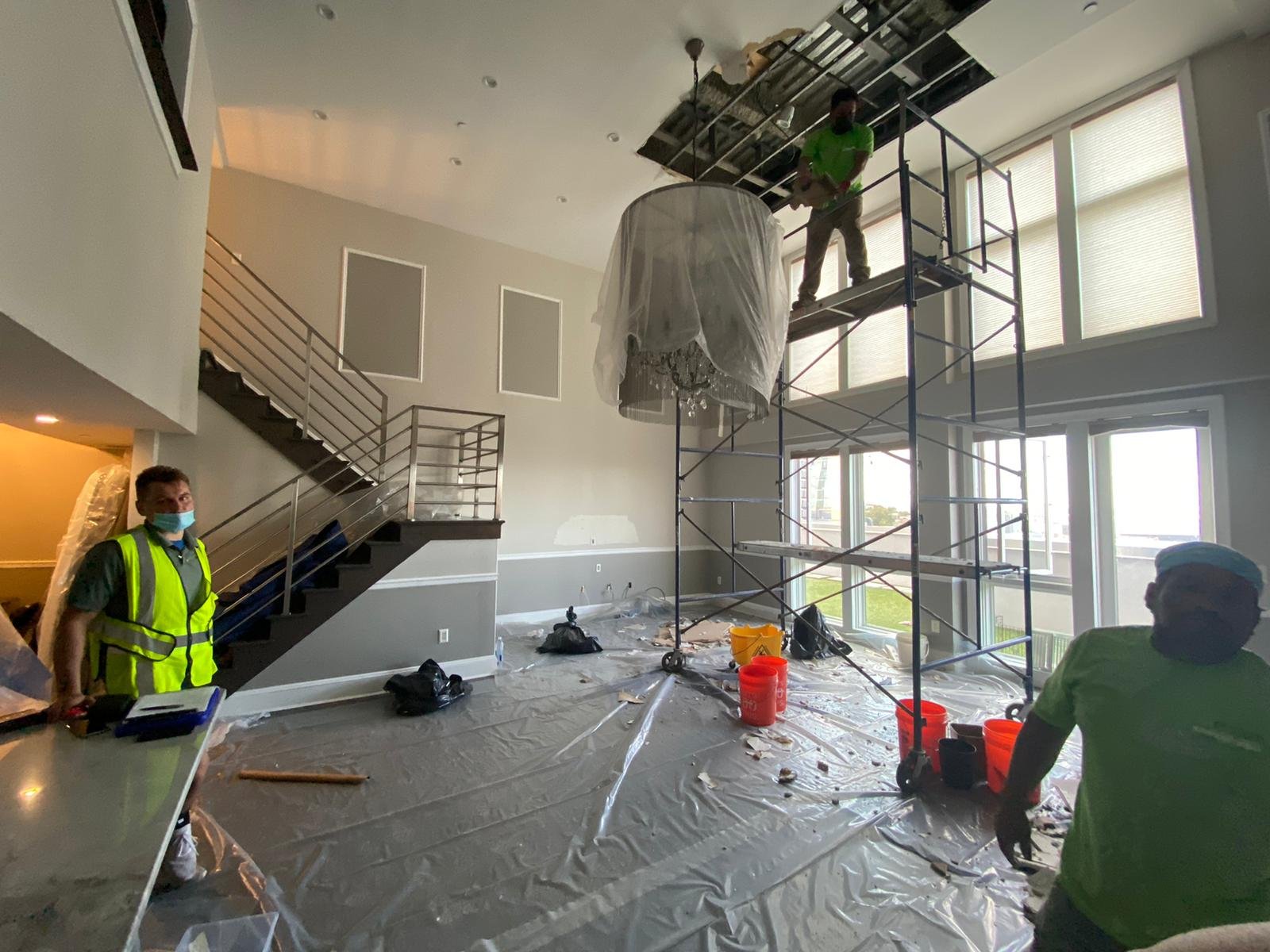 Anajur principal conducting an on-site water damage assessment with an insurance adjuster at a Staten Island residence