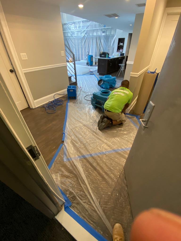 Anajur Construction crew on detail finish work at a Staten Island restoration job, representing the rebuild phase of the cleanup-to-rebuild service